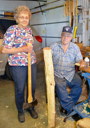 Leo Deitner, right, has been making wooden handles for all sorts of implements for the past 30 years. What makes his special? Well everything is done by hand. Using nothing more than a hand hatchet, a drawknife and some other hand tools, he can take a piece of wood like the one he is holding and turn it into a full sized axe handle like the one held by his wife Rita.   (Denny Scott photo)